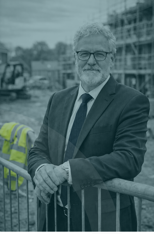Senior leader reviewing housebuilder development reports