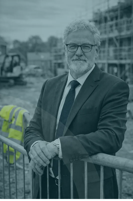 Senior leader reviewing housebuilder development reports