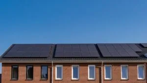 Newly build houses with solar panels attached on the roof against a sunny sky